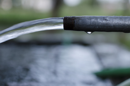 fresh drinking water flowing from pipeの写真素材