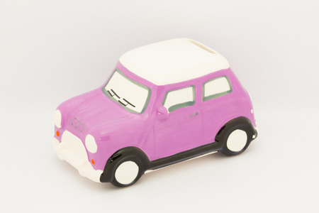 Toy car on money road isolated on white backgroundの写真素材