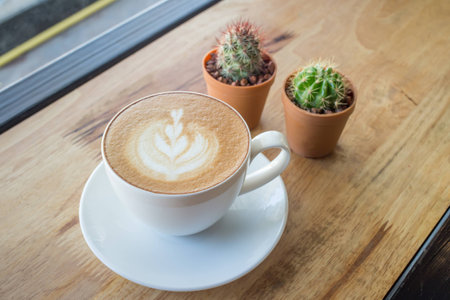 Coffee cup with milk on the tableの写真素材