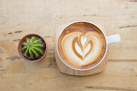 Cup of coffee on a table with flowersの写真素材