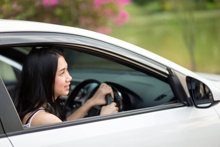 Young woman driving her carの写真素材