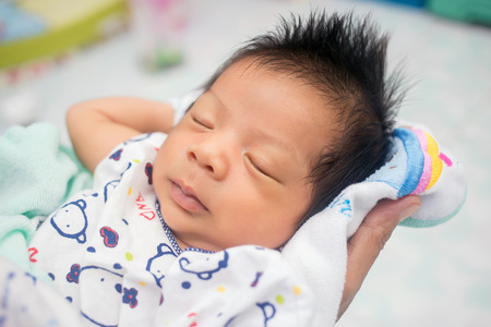 sleeping newborn baby on a blanket