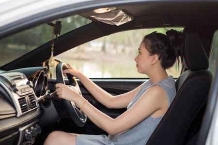 Young woman driving her carの写真素材