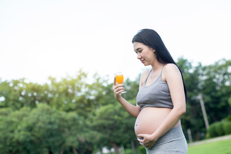 Pregnant Young Woman drinking Fresh Juiceの写真素材