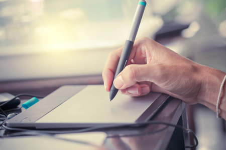 People writing on notebook and work with calculator and laptop on wooden tableの写真素材