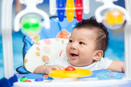 Portrait of a happy baby playing with toys.の写真素材