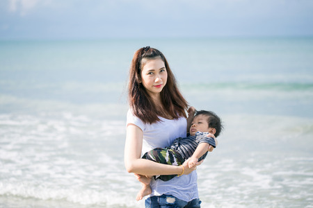 Young mother and her baby at the beach