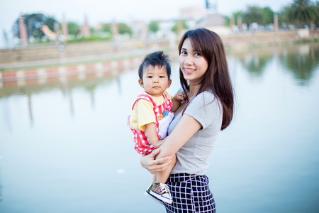 Mother and young son having fun in the parkの写真素材