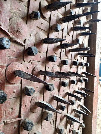 Old rusty nails on the wall of a temple, closeup of photo