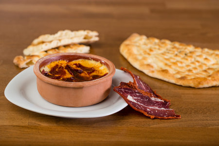 White bean hummus served with bacon and bread