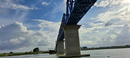 Bridge over the river with blue sky and white clouds in the backgroundの写真素材