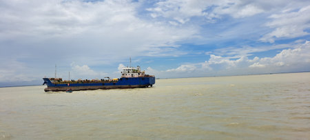 Barge in the sea with blue sky and white clouds background.の写真素材