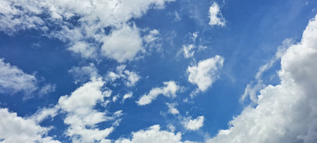Blue sky background with white clouds. Cumulus white clouds in the blue sky.の写真素材