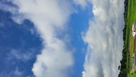 Clouds in the blue sky. Panoramic view from above.