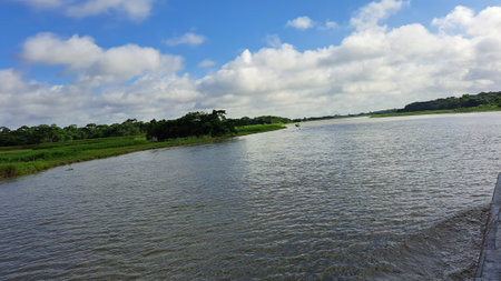 Landscape view of river and blue sky with white clouds on sunny dayの写真素材