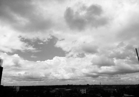 Clouds in the sky over the city. Black and white.の写真素材