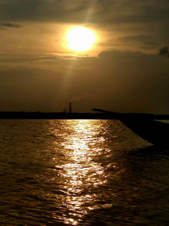 Sunset on the beach in the tropics. The sun is reflected in the water.の写真素材