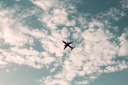 Airplane in the blue sky with white clouds, vintage tonedの写真素材