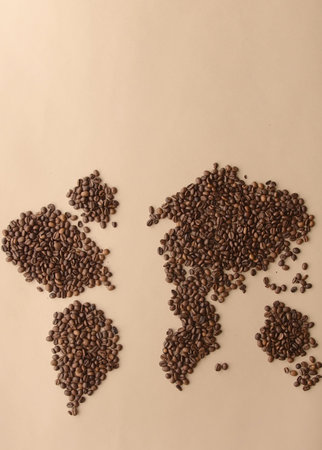 Coffee beans in the shape of a world map on a brown backgroundの写真素材
