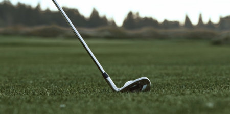 golf club and ball on the green grass, close-upの写真素材