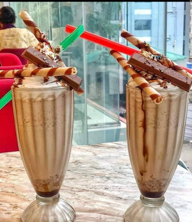 Chocolate milkshakes with whipped cream and chocolate wafersの写真素材