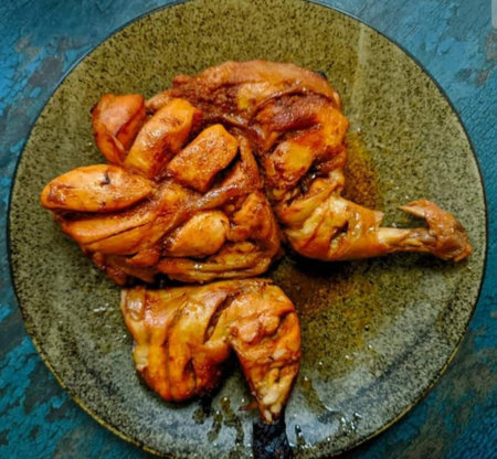 Grilled chicken on a plate, close-up, top view