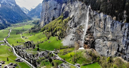 Panoramic view of the alps and a waterfall in Switzerlandの写真素材
