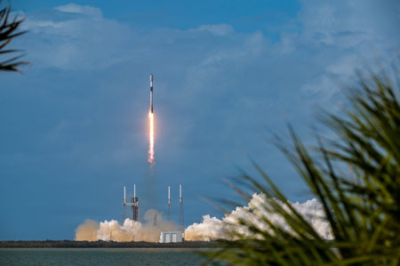 The rocket takes off from the water on a background of blue sky