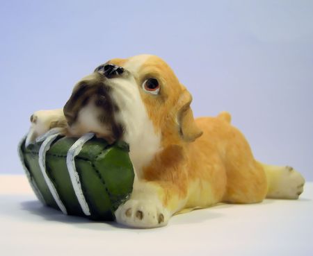 Ceramic figure of a dog with a gift. The close up.の写真素材