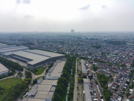 aerial view of residential community adjoining an industrial area.