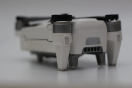 a close up of detailed white drone parts isolated on white background. drone camera photo concept.