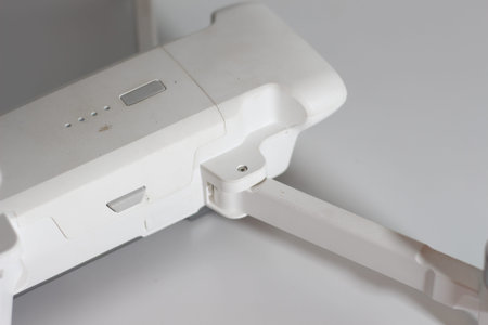 a close up of detailed white drone parts isolated on white background. drone camera photo concept.