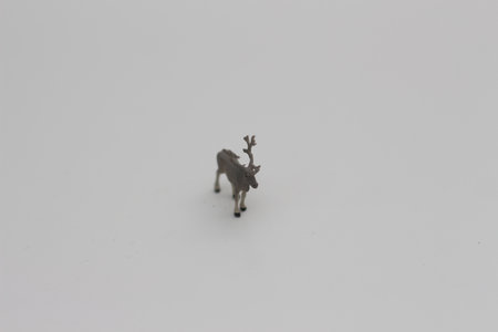 a close up of a miniature figure of a moose isolated on a white background. Miniature figure photo concept.の写真素材