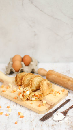 a close up of pastel cake which is a traditional indonesian food. filled with chicken, vegetables,...
