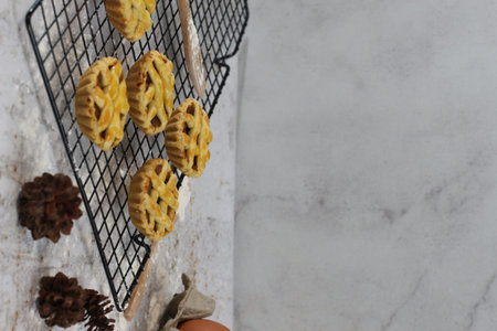 Small apple pie served on a cake rack, tastes sweet and savory. Food concept photo.