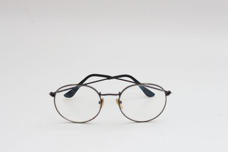 a close up of eyeglasses with black frames isolated on white background
