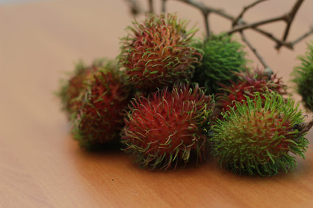rambutan fruit which is reddish green in color having sweet taste isolated on table. Food concept...