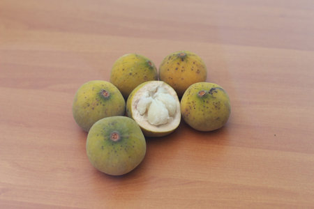 greenish yellow harp fruit isolated on money table has sweet and sour taste. Food concept photo.