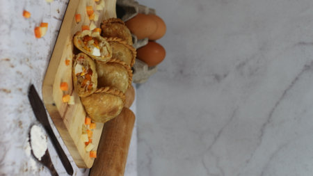 a close up of pastel cake which is a traditional indonesian food. filled with chicken, vegetables, or boiled eggs and served with sauce or chili. Indonesian traditional food photo concept.の写真素材