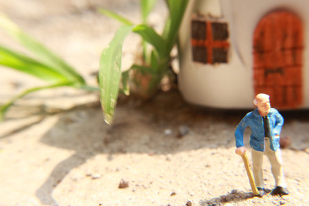miniature figure of a grandfather who is waiting in front of the house.