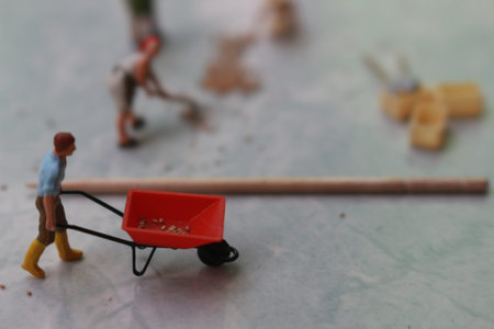 miniature figures of workers working together to move grain.の写真素材