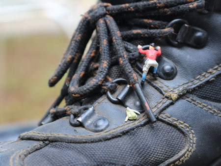 miniature figure of a climber climbing in outdoor shoes.の写真素材