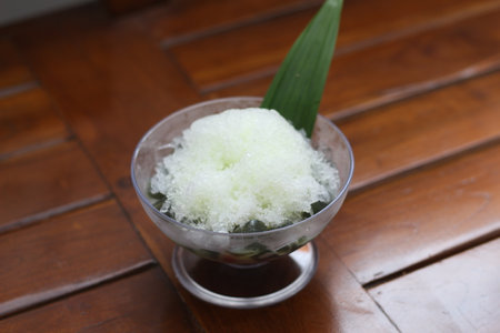 Es Kacang Merah or a cold drink made from red beans boiled with brown sugar served with coconut milk, shaved ice and covered with sweetened condensed milk chocolate and syrup. Indonesian traditional food photo concept.の写真素材