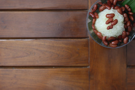 Es Kacang Merah or a cold drink made from red beans boiled with brown sugar served with coconut milk, shaved ice and covered with sweetened condensed milk chocolate and syrup. Indonesian traditional food photo concept.の写真素材