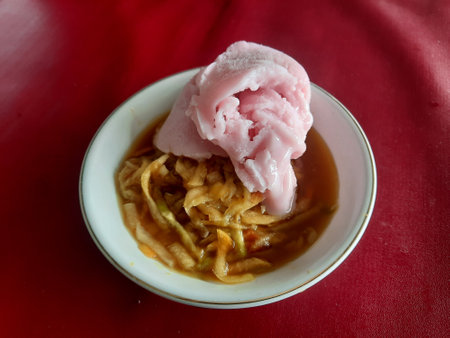a rujak or spicy fruit salad dish topped with strawberry ice cream. has a cold sweet and sour taste into one. Rujak Eskrim from Yogyakarta.の写真素材