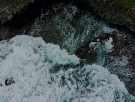 Aerial view of the waves hitting the coastal reefs in Yogyakarta, Indonesia. natural concept. beach.の写真素材