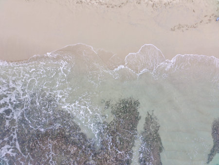 aerial top down view of beautiful sand beach and coral reefs in Yogyakarta, Indonesia. natural...
