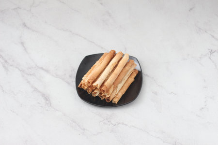 egg roll or Semprong is very good to serve as one of snacks that normally serve on Hari Raya or Eid Al Fitr. Indonesian traditional food. Selective focus.の写真素材