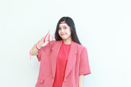 portrait of beautiful asian woman wearing red outfit with agree or OK gesture while smiling for celebrating Indonesia independence day isolated white background.の写真素材