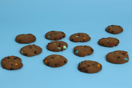 a close up of chocolate cookies with rainbow chips isolated on bright background. Food concept...